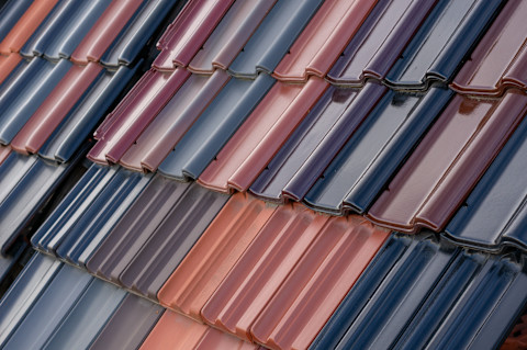 Closeup of multicoloured roof tiles on a house.
