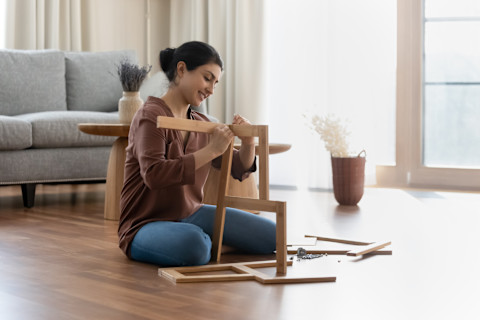 Lady assembling some new furniture.