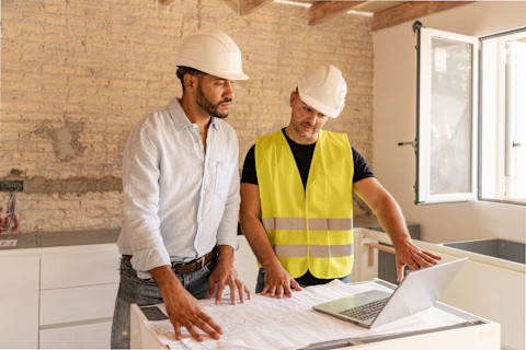 Two architects are working on some plans for a new build