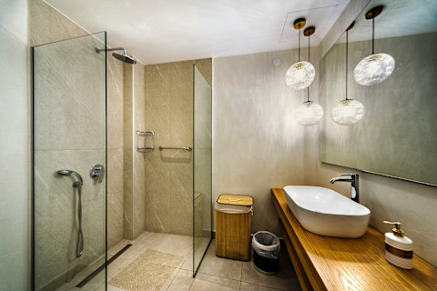 A modern bathroom with wooden elements and mirrors