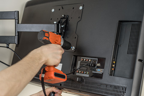 A drill on the back of a tv