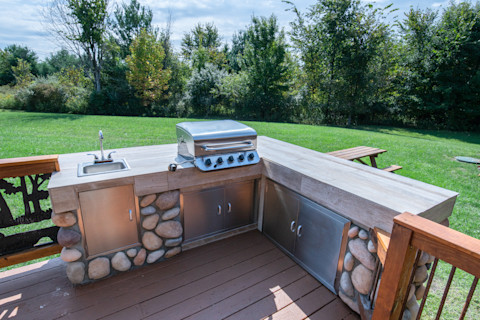 An outdoor kitchen with barbecue