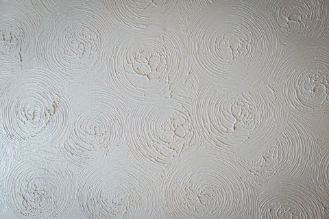 A textured white ceiling with spirals.