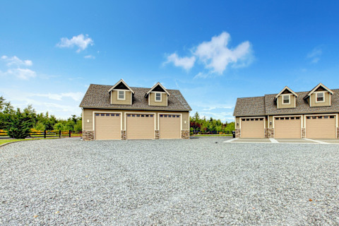This image shows a large multi-garage driveway with grey gravel.