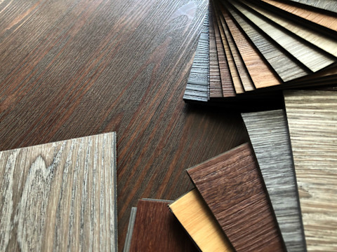 Different samples of luxury vinyl plank flooring in a fan formation.