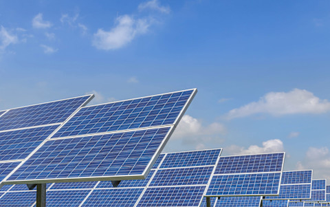 Several solar panels in rows, photo taken from below.