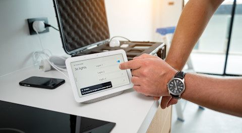 A professional is checking a new home automation system.
