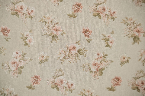 A vintage wallpaper design. Grey with light pink flowers.