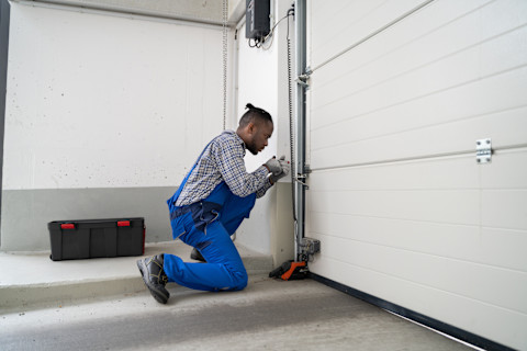 A man is busy fitting a new garage door.