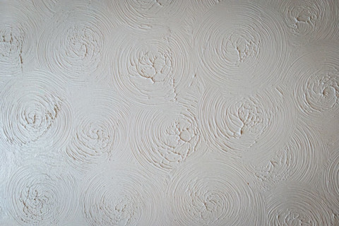 A textured white ceiling with spirals.