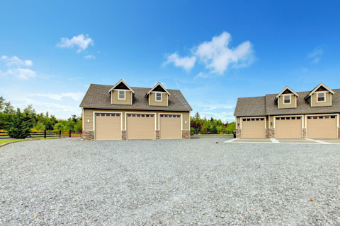 This image shows a large multi-garage driveway with grey gravel.