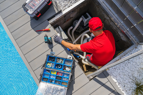 Technician maintaining pool equipment