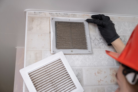 A pro is clearing out an air duct.