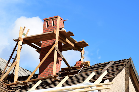 This image shows scaffolding around a chimney in preparation for it being repaired, removed or maintained.