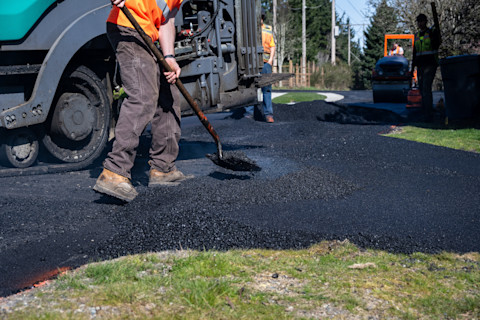 Asphalt being placed on a driveway