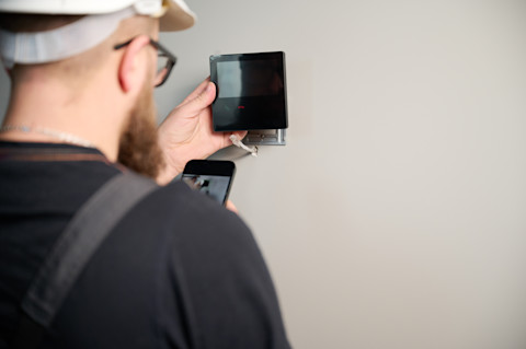 A professional is fitting a new automation system.