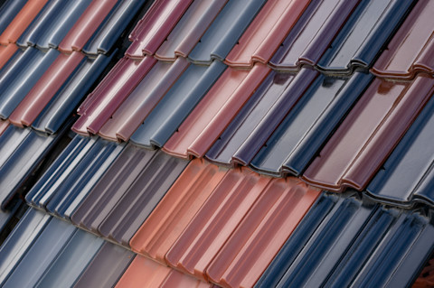 Closeup of multicoloured roof tiles on a house.