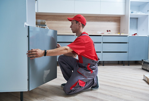A professional is fitting a new kitchen.