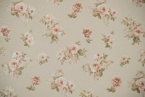 A vintage wallpaper design. Grey with light pink flowers.