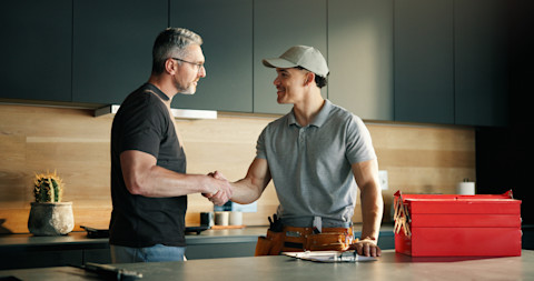 A man is shaking hands with a contractor.