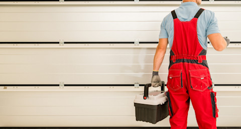 A man is checking out a new garage door
