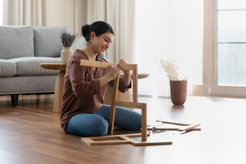 Lady assembling some new furniture.