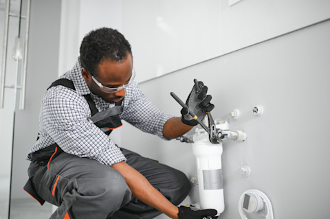 Plumber is installing a water conditioner