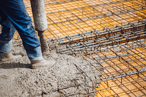 worker pouring concrete