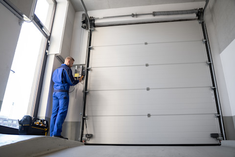 A pro is busy installing a new garage door.